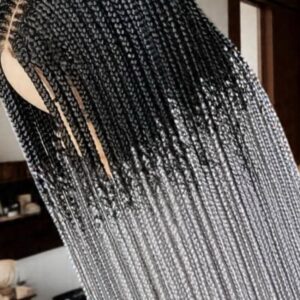 A person with a long tribal braids wig on their head